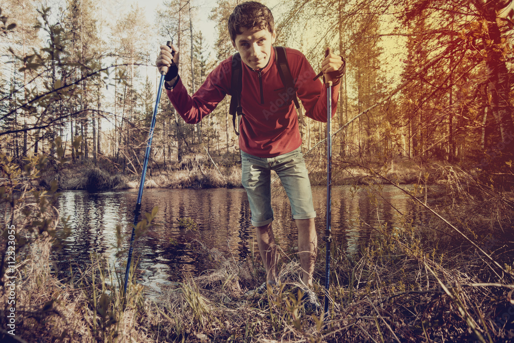 Hiker with hiking poles in a forest Hiker with hiking poles in a forest