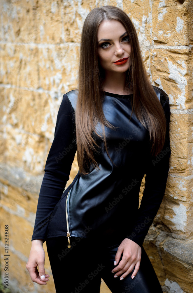 portrait of model posing outdoors in black leather clothes