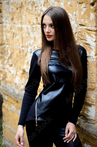 portrait of model posing outdoors in black leather clothes © patramansky