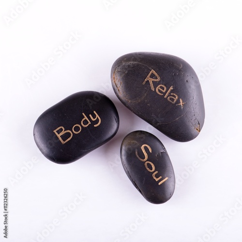 Top view on three lava stones on white board photo