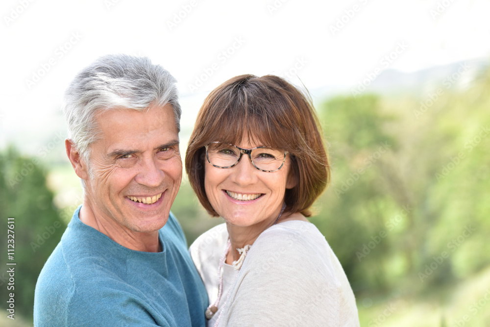 Senior couple embracing each other outside Senior couple embracing each other outside