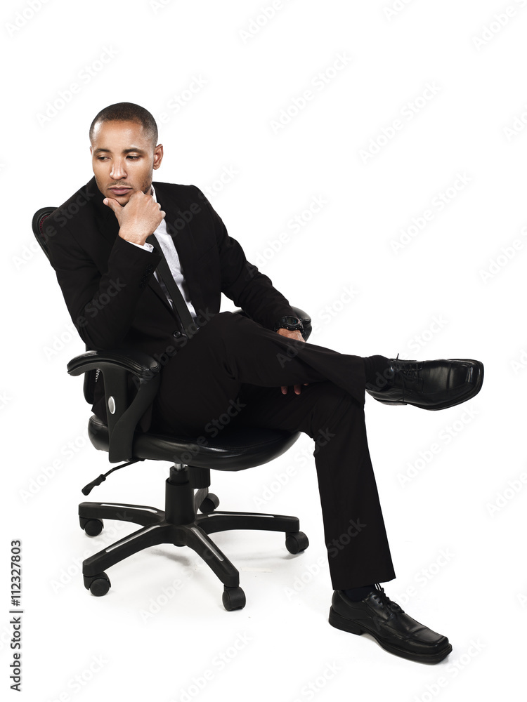 thoughtful businessman sitting on chair with hand on chin. thoughtful businessman sitting on chair with hand on chin.