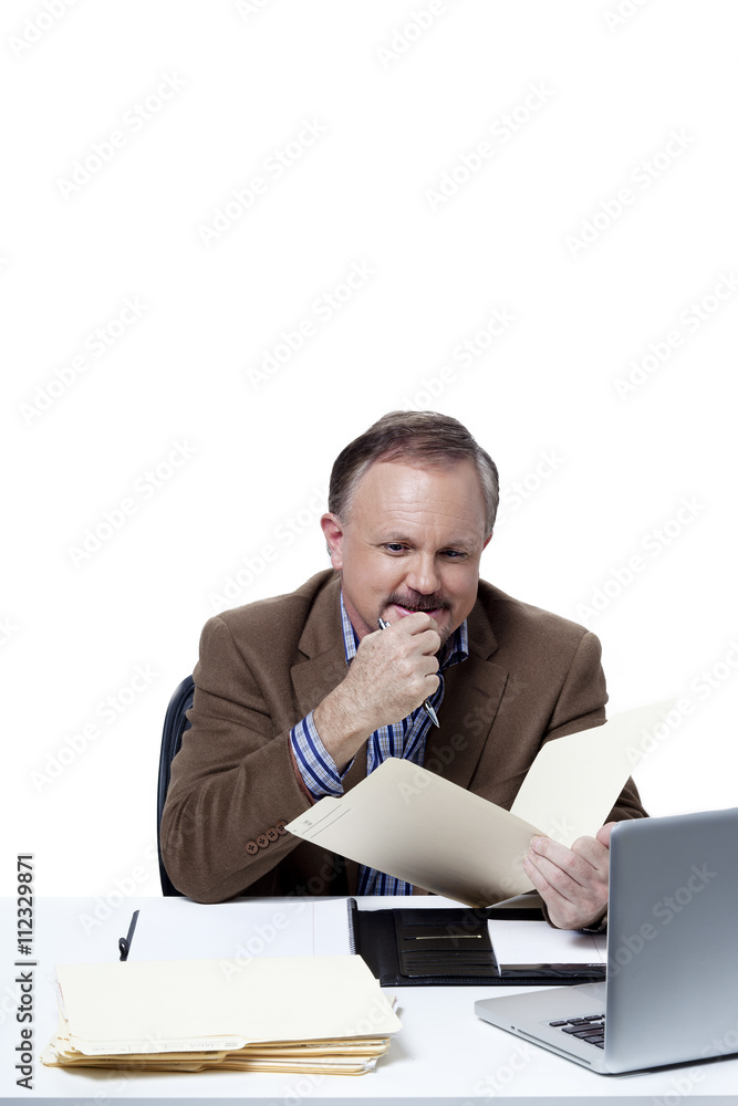 mature businessman studying a file. mature businessman studying a file.