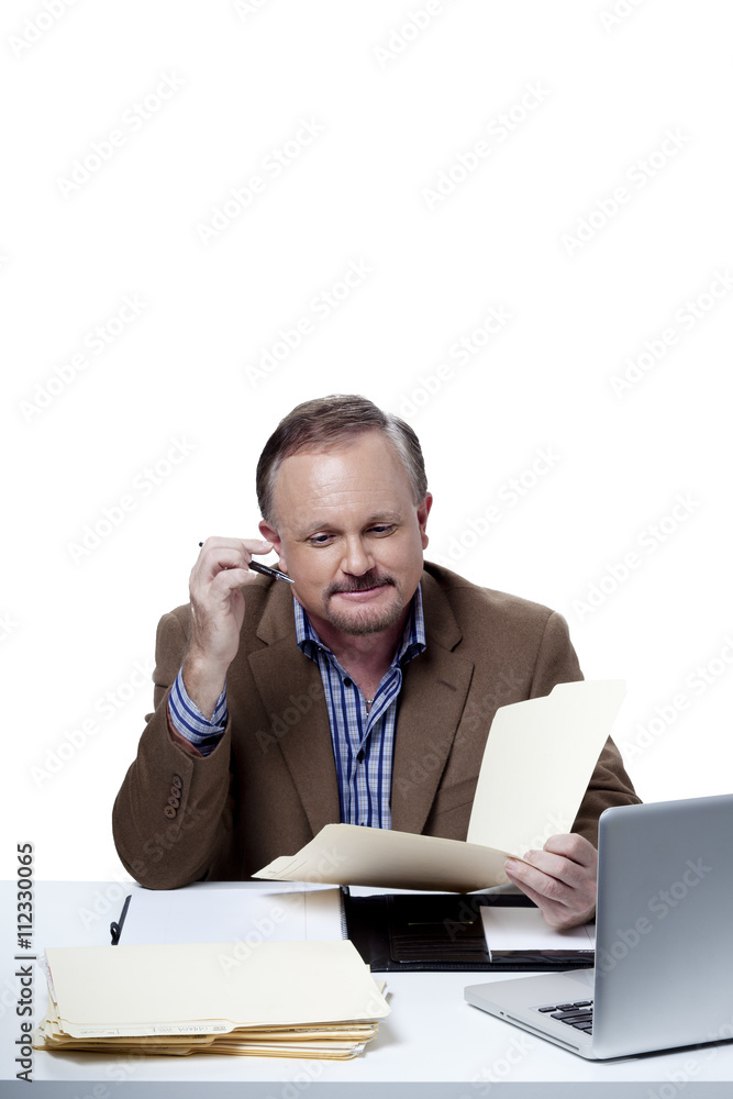 smart mature businessman reading office report. smart mature businessman reading office report.