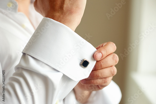 Man correcting the sleeve of his shirt