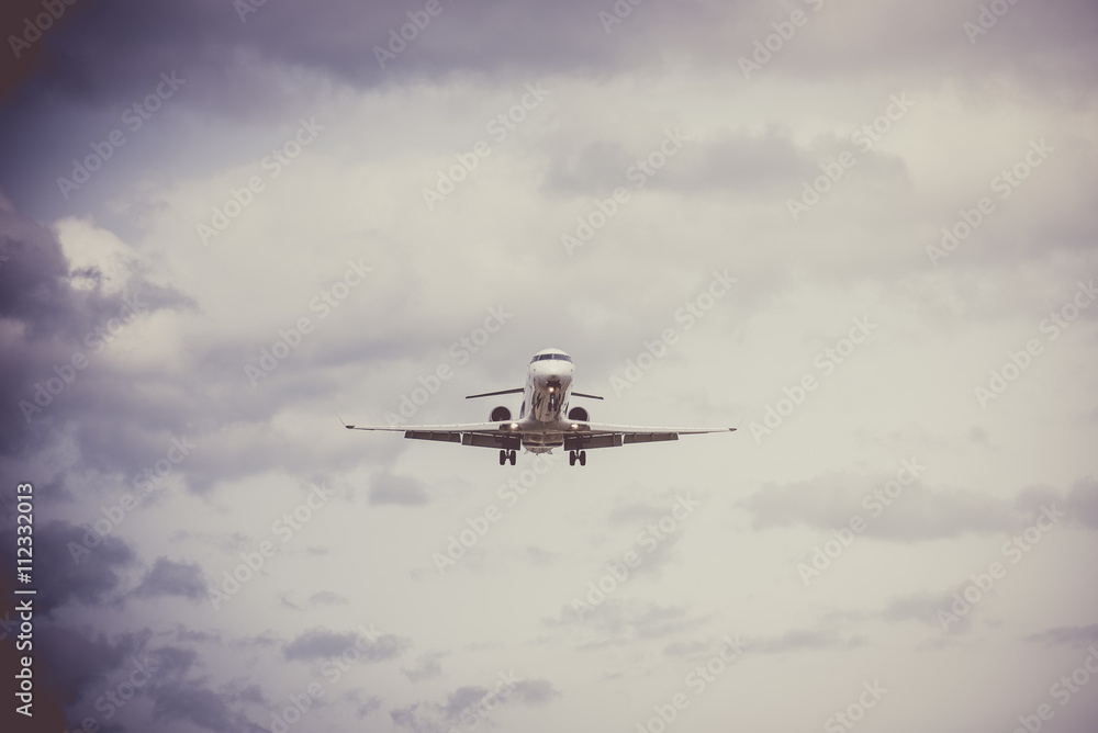 Airplane flying with clouds in background Airplane flying with clouds in background