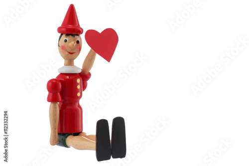 Pinocchio toy statue with heart isolated on white