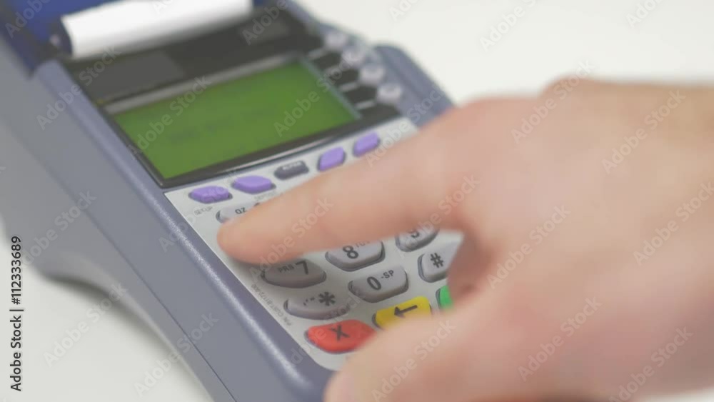 Paying with a credit card on a store terminal and entering the PIN number to complete the transaction. Great to illustrate a shopping experience. Paying with a credit card on a store terminal and entering the PIN number to complete the transaction. Great to illustrate a shopping experience.