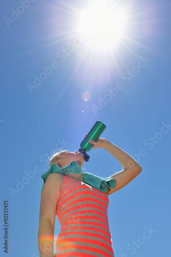 Young sports woman enjoys fitness and bright sunshine