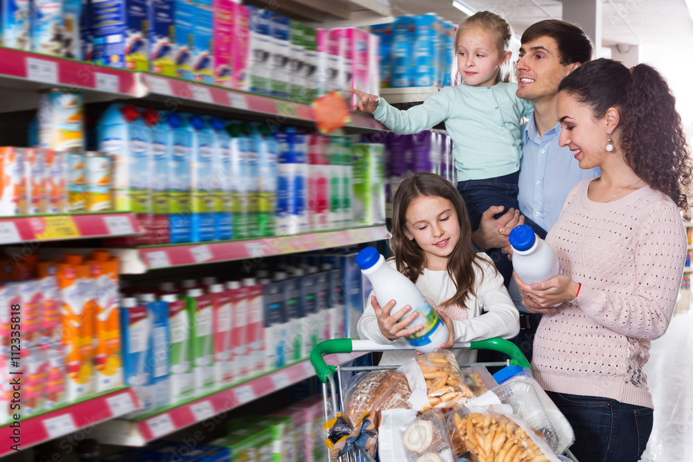 Couple with children choosing dairy products