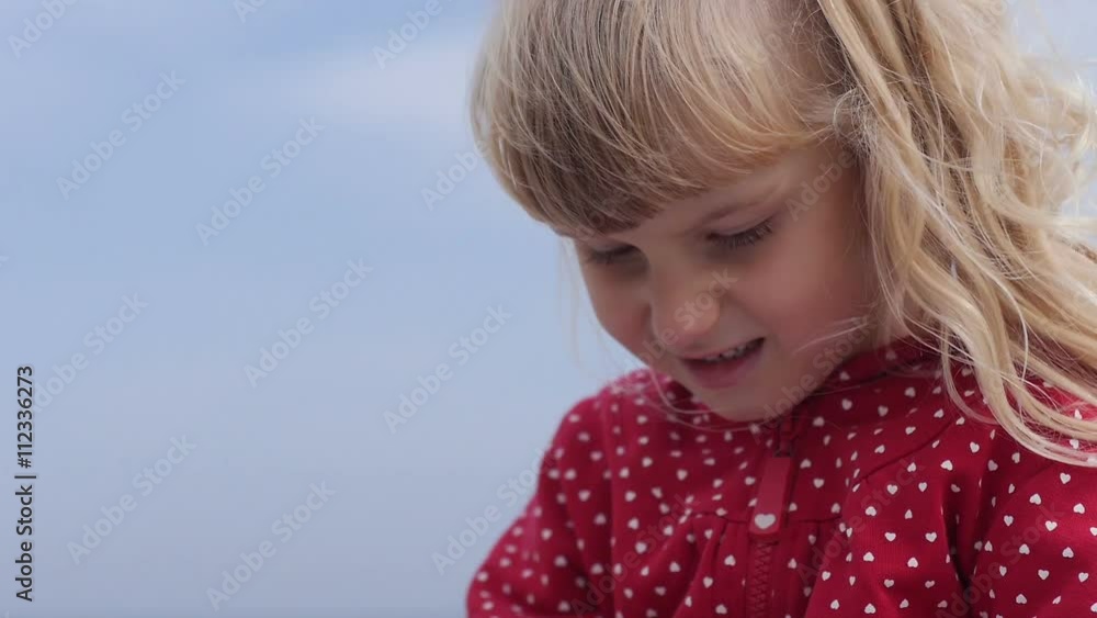 Little girls hands writing in the notebook near the sea Little girls hands writing in the notebook near the sea