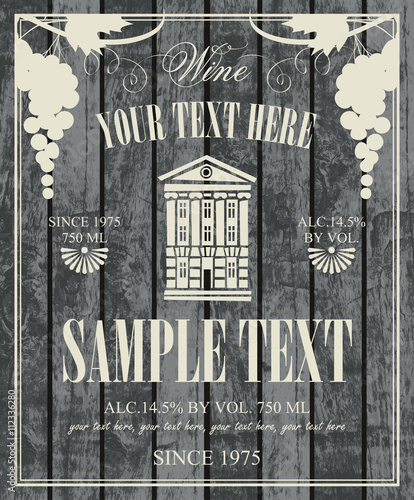 wine label with a picture of vintage home with a bunch of grapes on a background of wooden planks