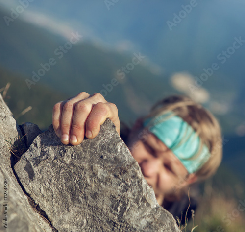 Young man finishing his extreme mountain climb