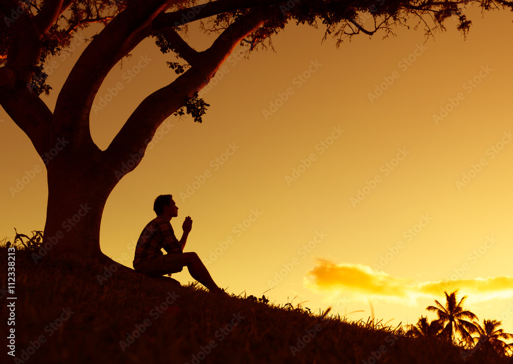 Man praying, meditating in harmony and peace at sunset

 - obrazy, fototapety, plakaty 