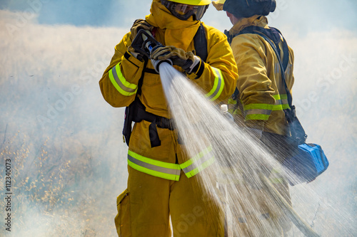 Firefighter Fighting Wildland Forest Grass Fire photo