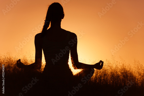Fototapeta Naklejka Na Ścianę i Meble -  Healthy mind body spirt. Woman doing Yoga outdoors. 