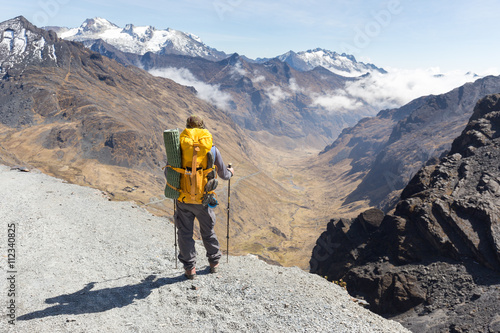 Backpacker standing hiking tourist mountain edge trail, Bolivia