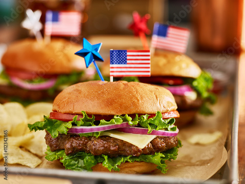 cheesebuergers in tray with potato chips patriotic american theme