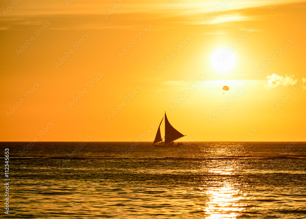 Sunset in Boracay, Philippines with a boat in foreground