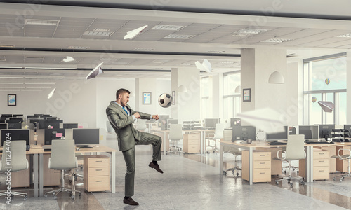 Playing football in office © Sergey Nivens