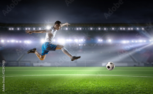 Soccer player hitting ball © Sergey Nivens