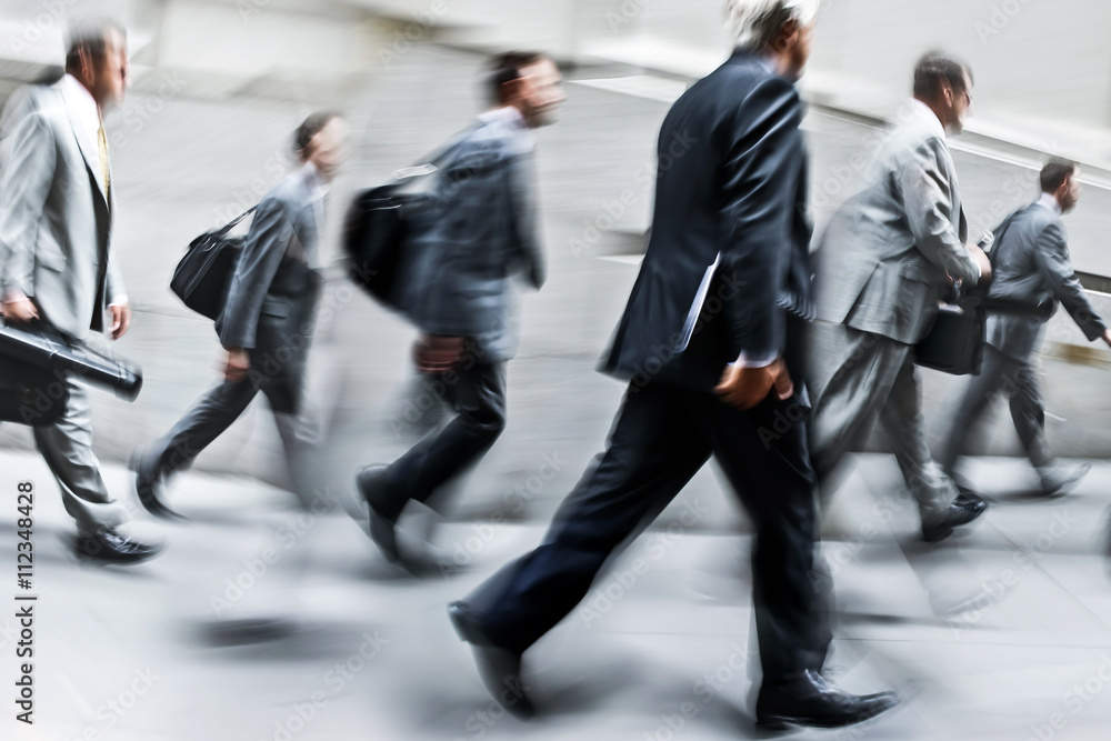 motion blurred business people walking on the street motion blurred business people walking on the street