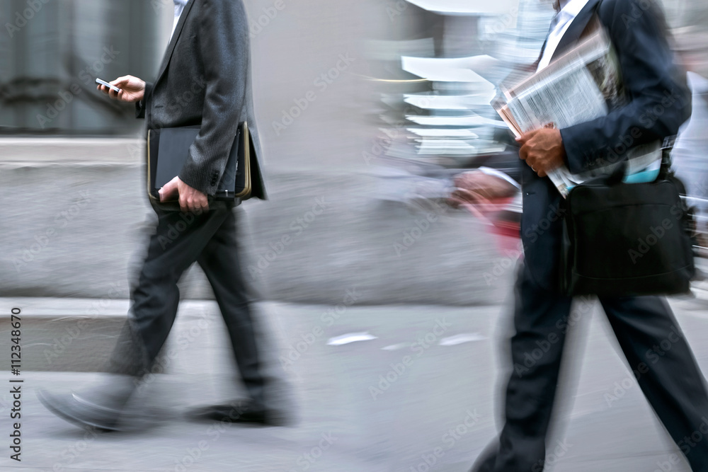 motion blurred business people walking on the street motion blurred business people walking on the street