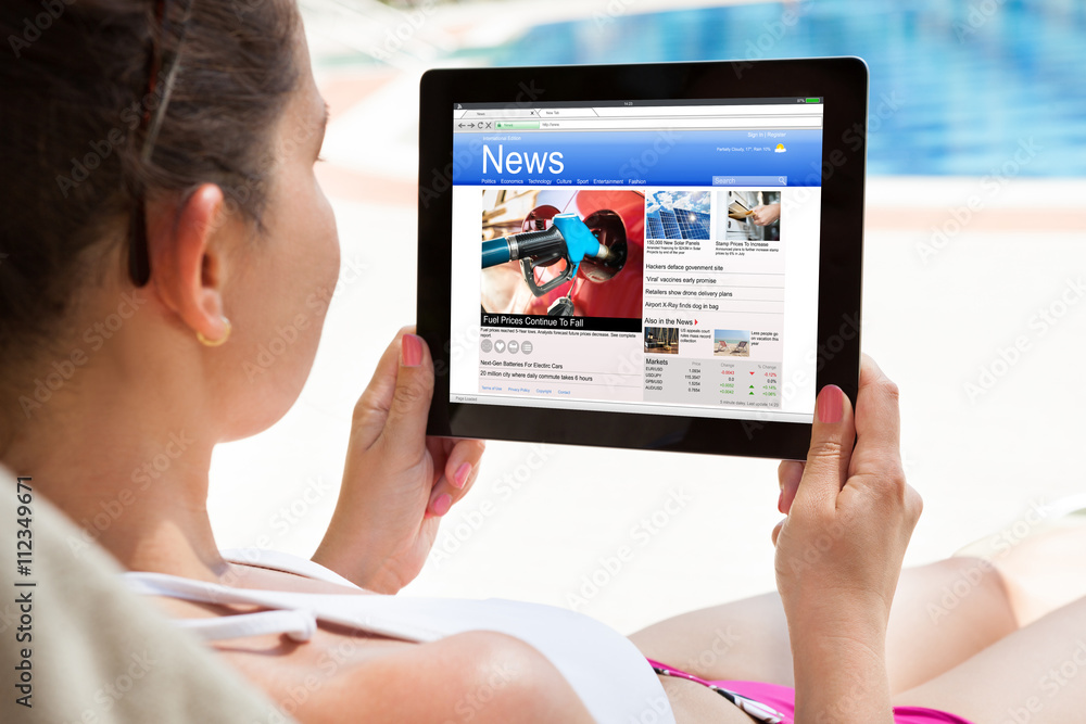 Woman Reading News On Digital Tablet Woman Reading News On Digital Tablet