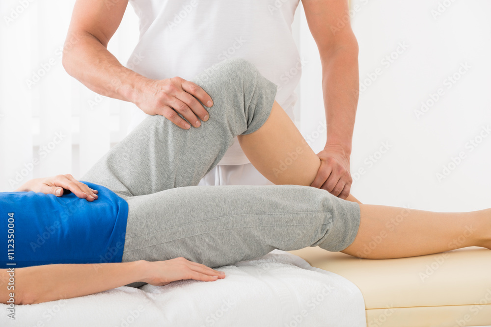 Close-up Of Therapist Doing Knee Massage
