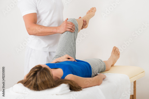 Woman Receiving Leg Massage In Spa