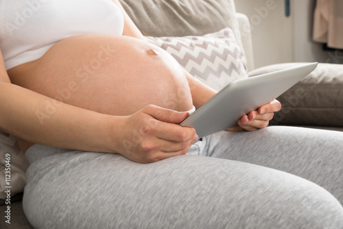 Pregnant Woman Using Digital Tablet