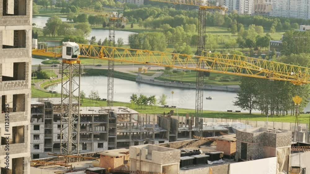 view of the construction site with cranes working. view of the construction site with cranes working.