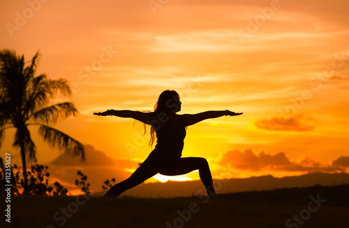 Body balance and fitness concept. Woman doing yoga outdoors in a beautiful setting.