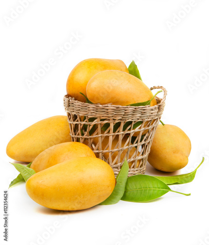 Fresh mango and leaves in basket isolated white background