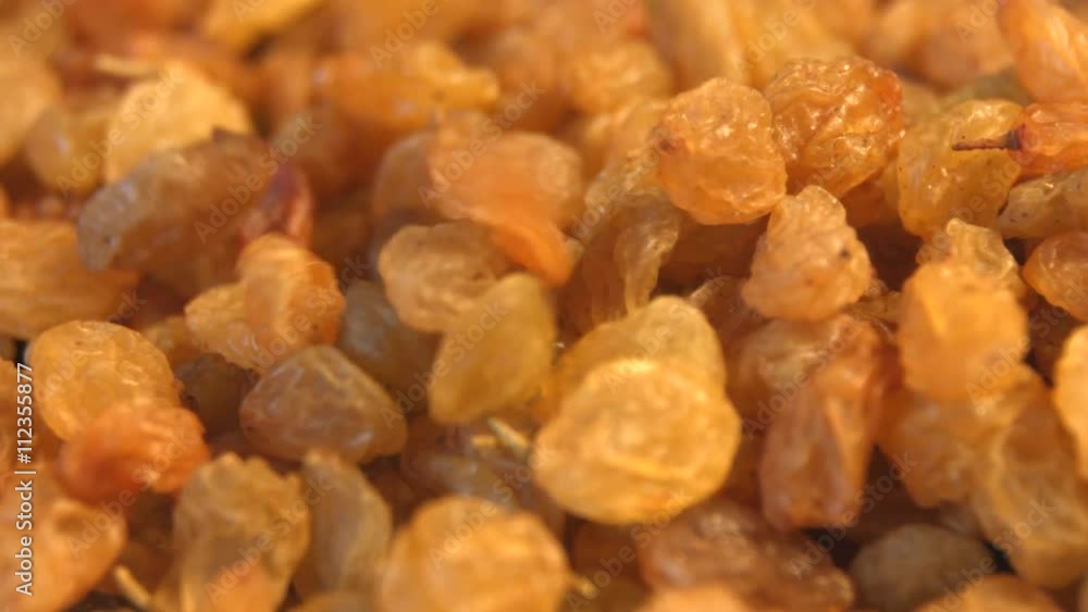Raisins on a white background. 2 Shots. Horizontal pan. Slow motion. Close-up. Raisins on a white background. 2 Shots. Horizontal pan. Slow motion. Close-up.