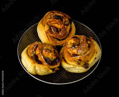 nut rolls on a plate with black background