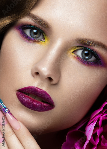 Fotografie Beautiful girl with colorful make-up, flowers. beauty face.