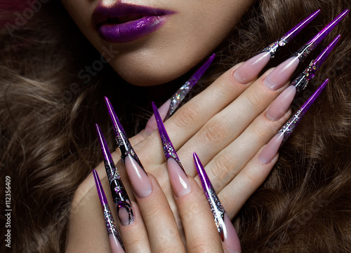 Portrait of woman with creative art makeup and long nails. Manicure design, beauty face.