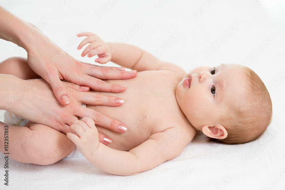 Baby massage. Mom massaging child belly. Treatment of colic Baby massage. Mom massaging child belly. Treatment of colic