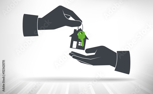 House handover. House key with small house key ring given from one hand to another