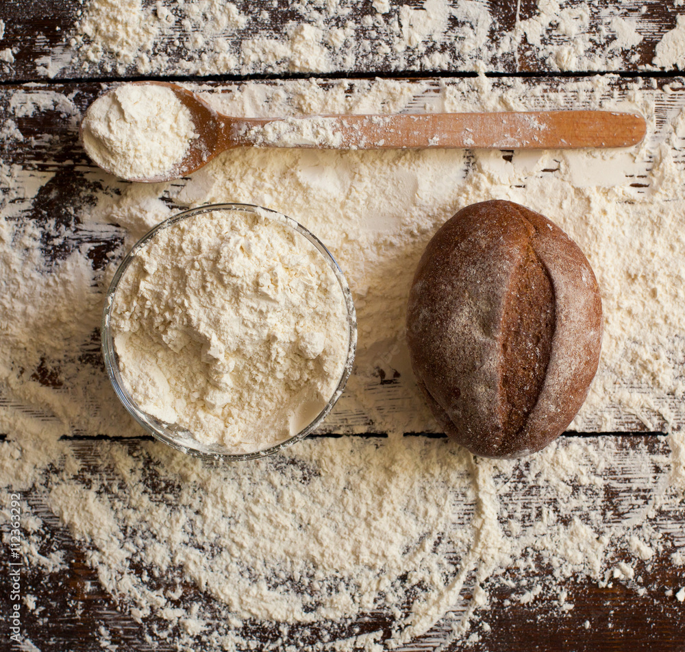 Bread and flour on the table Bread and flour on the table