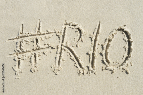 Hashtag social media message for Rio written in smooth sand on the beach in Rio de Janeiro, Brazil