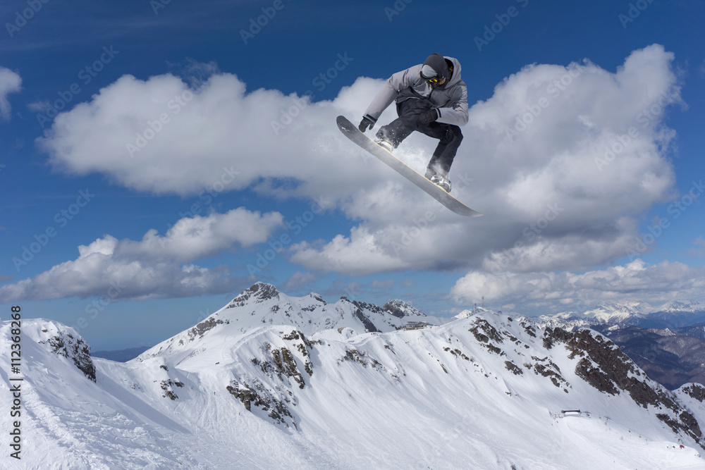 Snowboard rider jumping on mountains. Extreme snowboard freeride sport. Snowboard rider jumping on mountains. Extreme snowboard freeride sport.