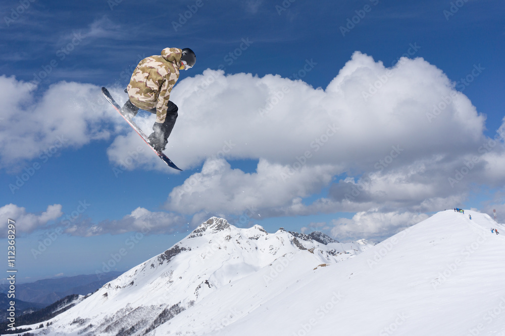 Photo & Art Print Snowboard rider jumping on mountains