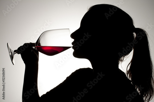 Canvas Print silhouette of a girl sipping on red wine