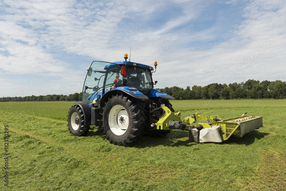 pasture mowing with blue tractor and mower pasture mowing with blue tractor and mower