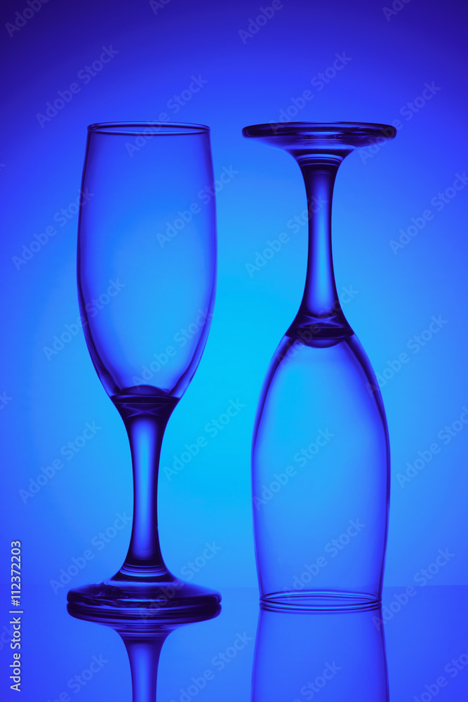 Two empty glasses in blue light Two empty glasses in blue light