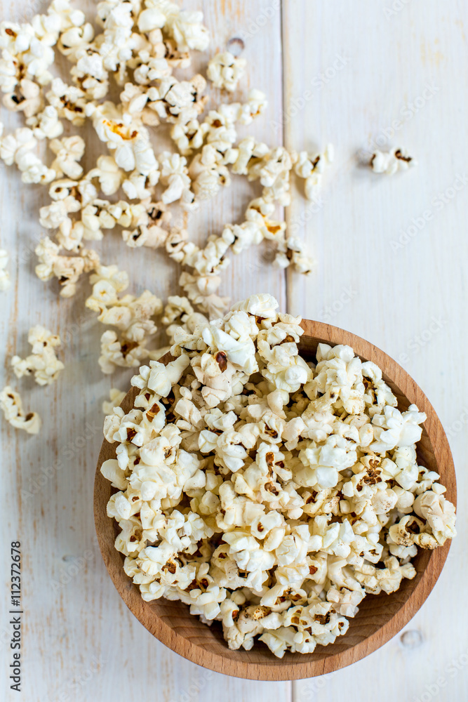Popcorn in wooden bowl. View from above. Popcorn in wooden bowl. View from above.