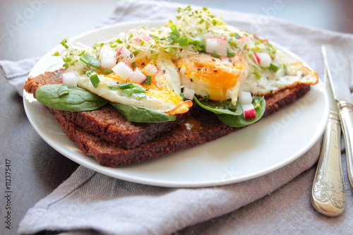 Healthy sandwich with poached eggs and vegetables