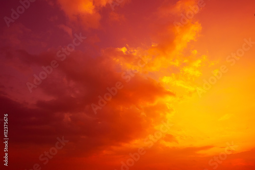 Colorful tropical sky with golden clouds at sunset time